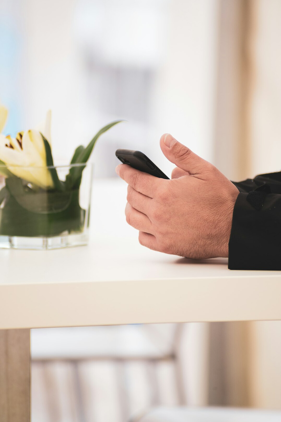 Young professional checking a corporate wellness app on a smartphone at their desk
