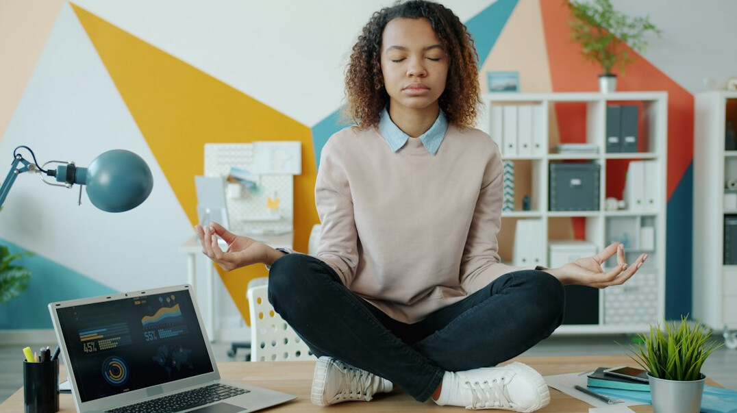 person meditating in office